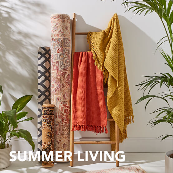 A collection of blankets, rugs and runners styled over a stand.